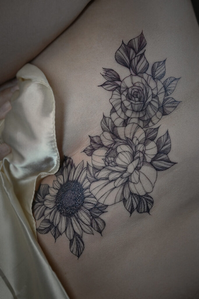 Aesthetic Tattoo Art| Fine line rib tattoo of a rose, peony and sunflower