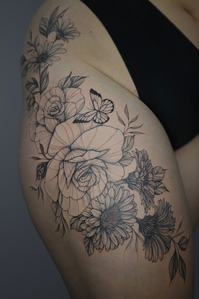 Aesthetic Tattoo Art| Fine line sleeve tattoo of roses, sunflowers, butterfly and ladybug