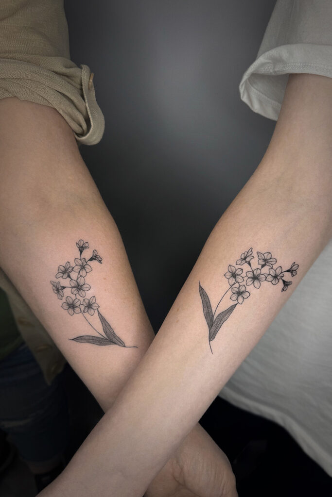 Aesthetic Tattoo Art| Fine line matching tattoos of stems of flowers